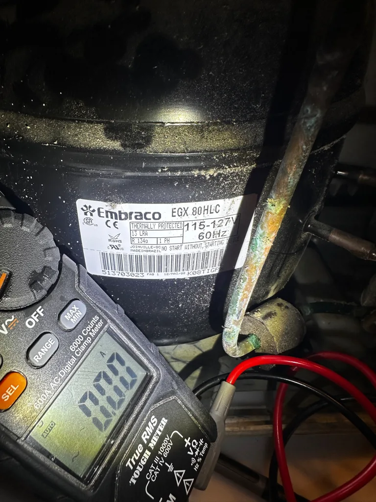 Testing the compressor of a Bosch refrigerator with a meter