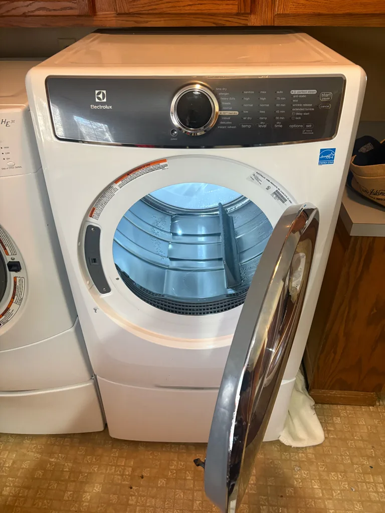 White Electrolux front-load dryer in a Denver-area laundry room