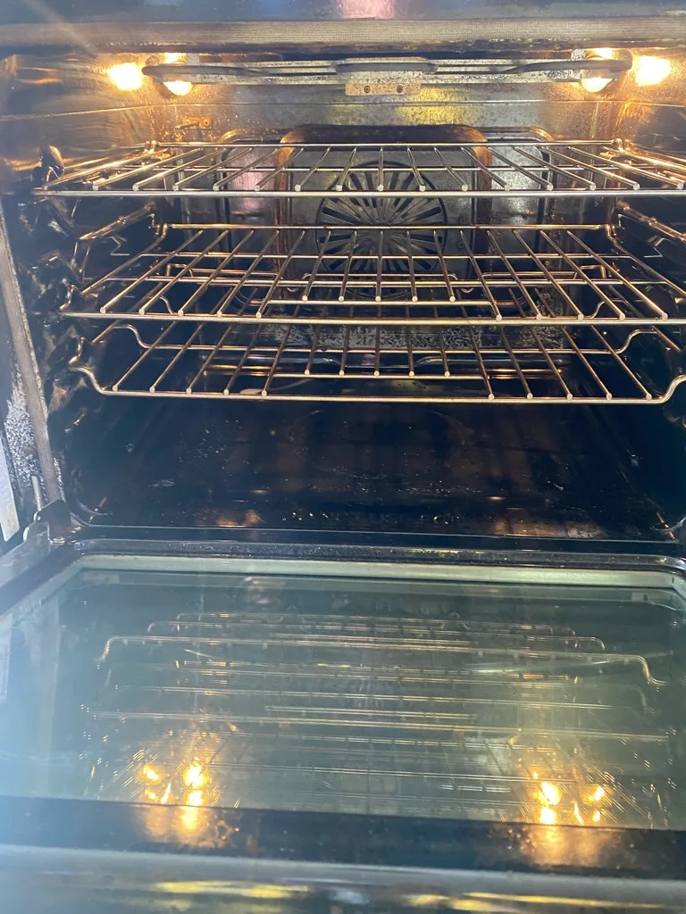 Inside a Frigidaire convection oven with racks and lights on