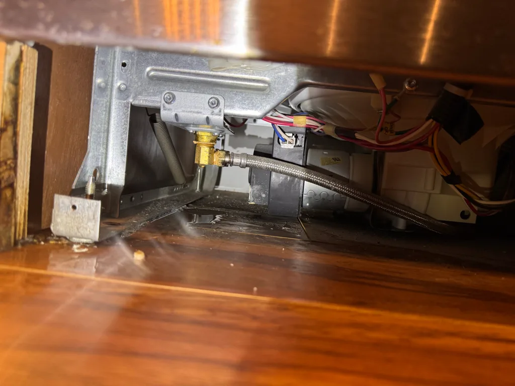 Water inlet valve area under a leaking Frigidaire dishwasher