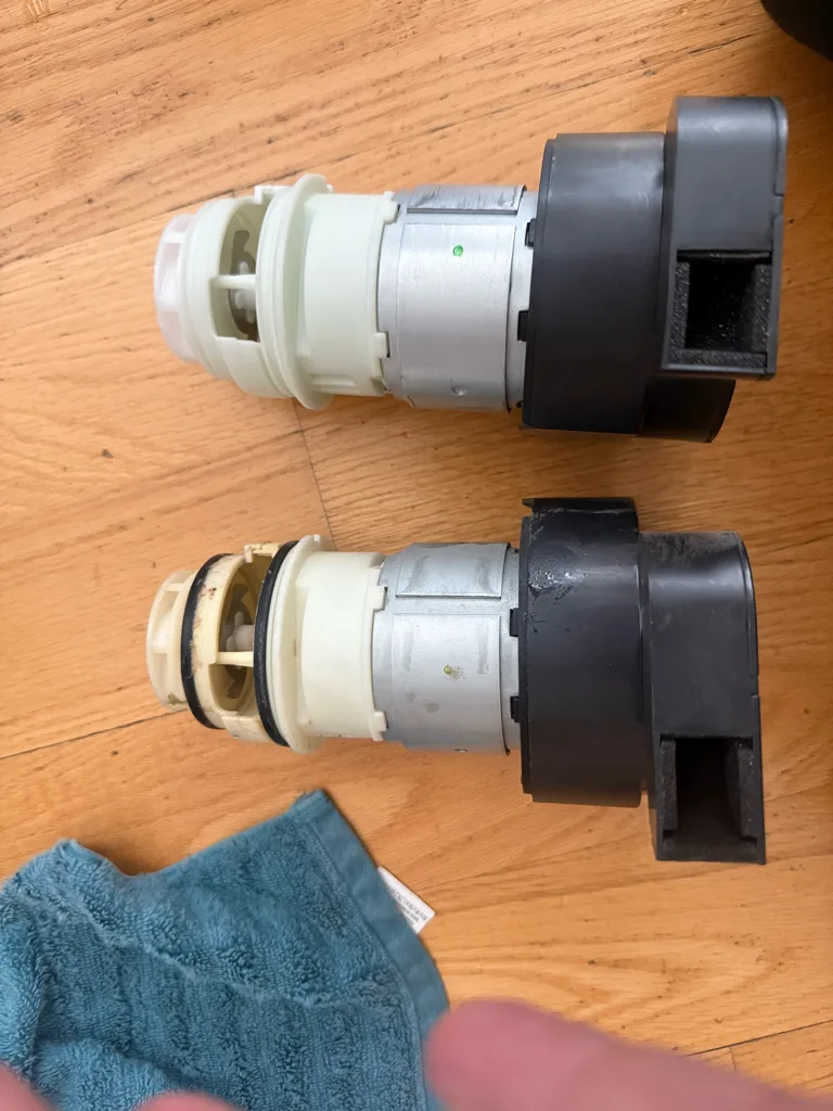 Old and new motor and pump assemblies from a Frigidaire dishwasher