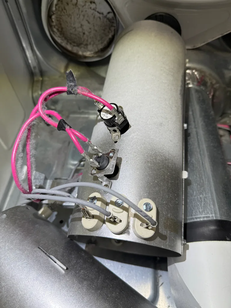 Heater housing and thermostat wiring of a Frigidaire dryer