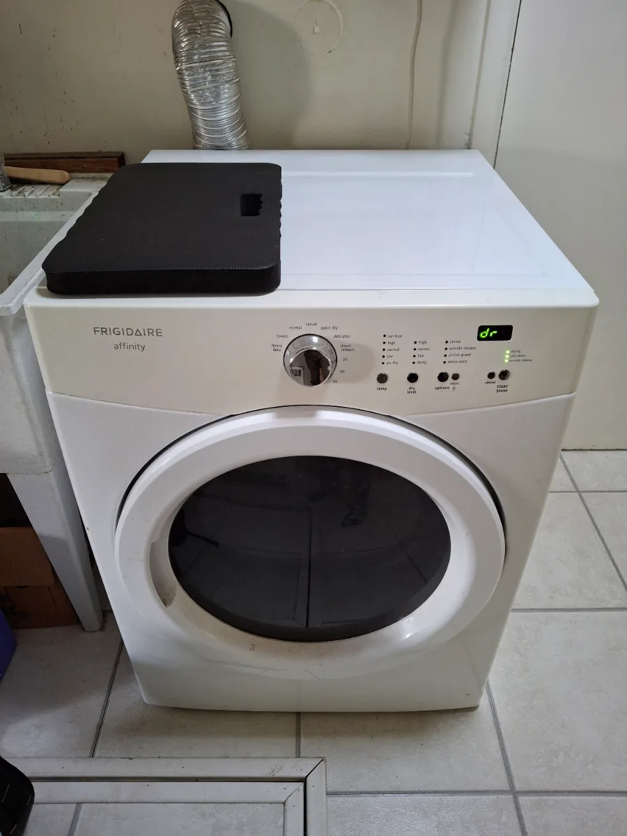 White Frigidaire front-load dryer in a Denver-area laundry room