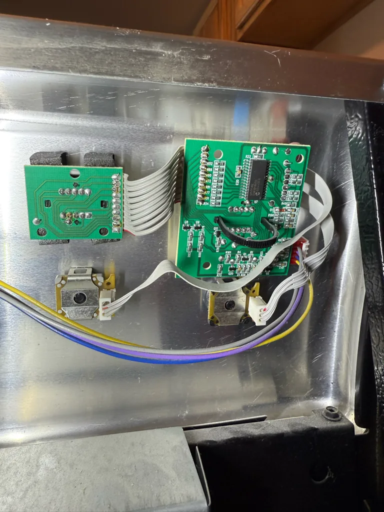 Switch control boards behind the console of a Frigidaire electric range