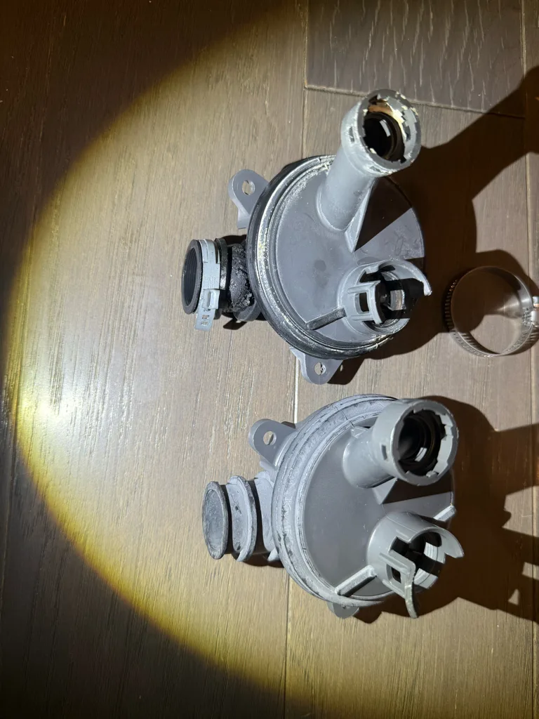 Two pump housings from a leaking GE dishwasher