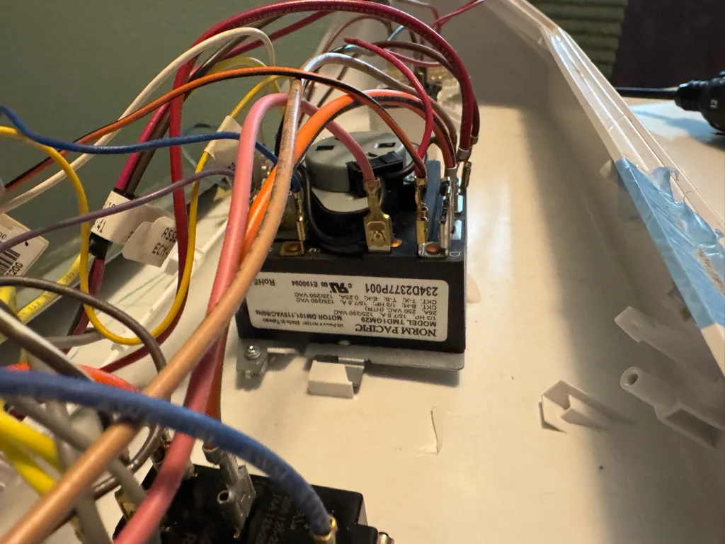 Timer and wiring inside the control console of a GE dryer