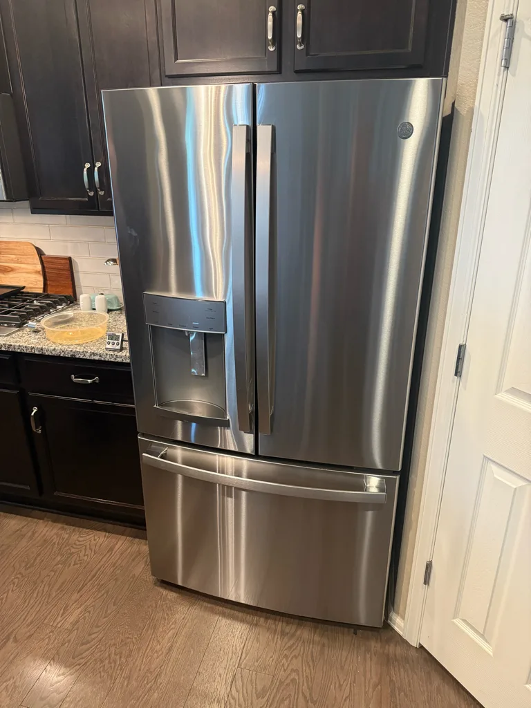 Stainless GE French-door refrigerator with an external dispenser in a Denver-area kitchen