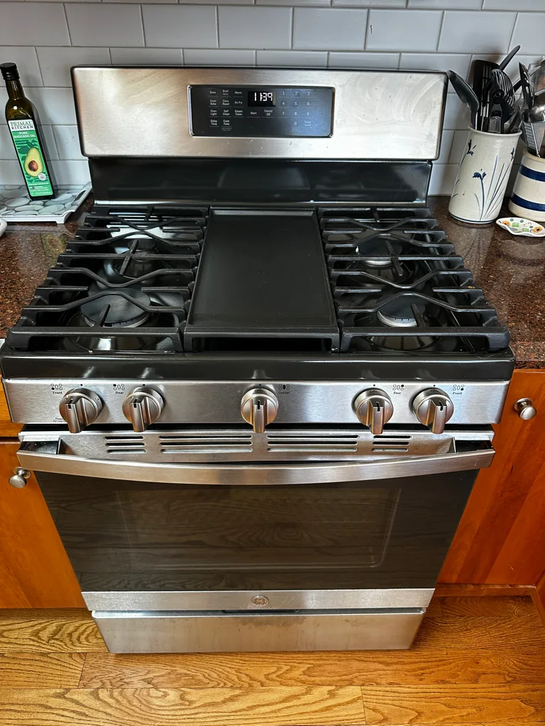 GE gas range with a center griddle in a Denver-area kitchen