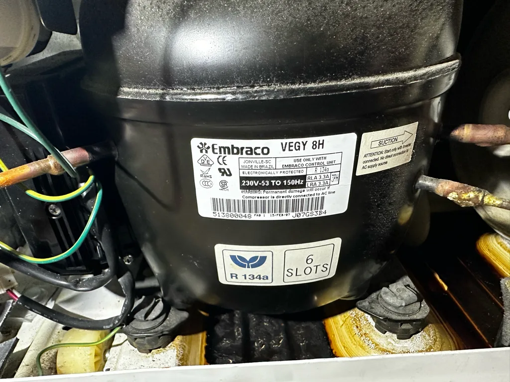 Compressor of a GE refrigerator in the machine compartment