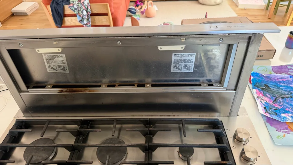 JennAir downdraft vent raised above a gas cooktop