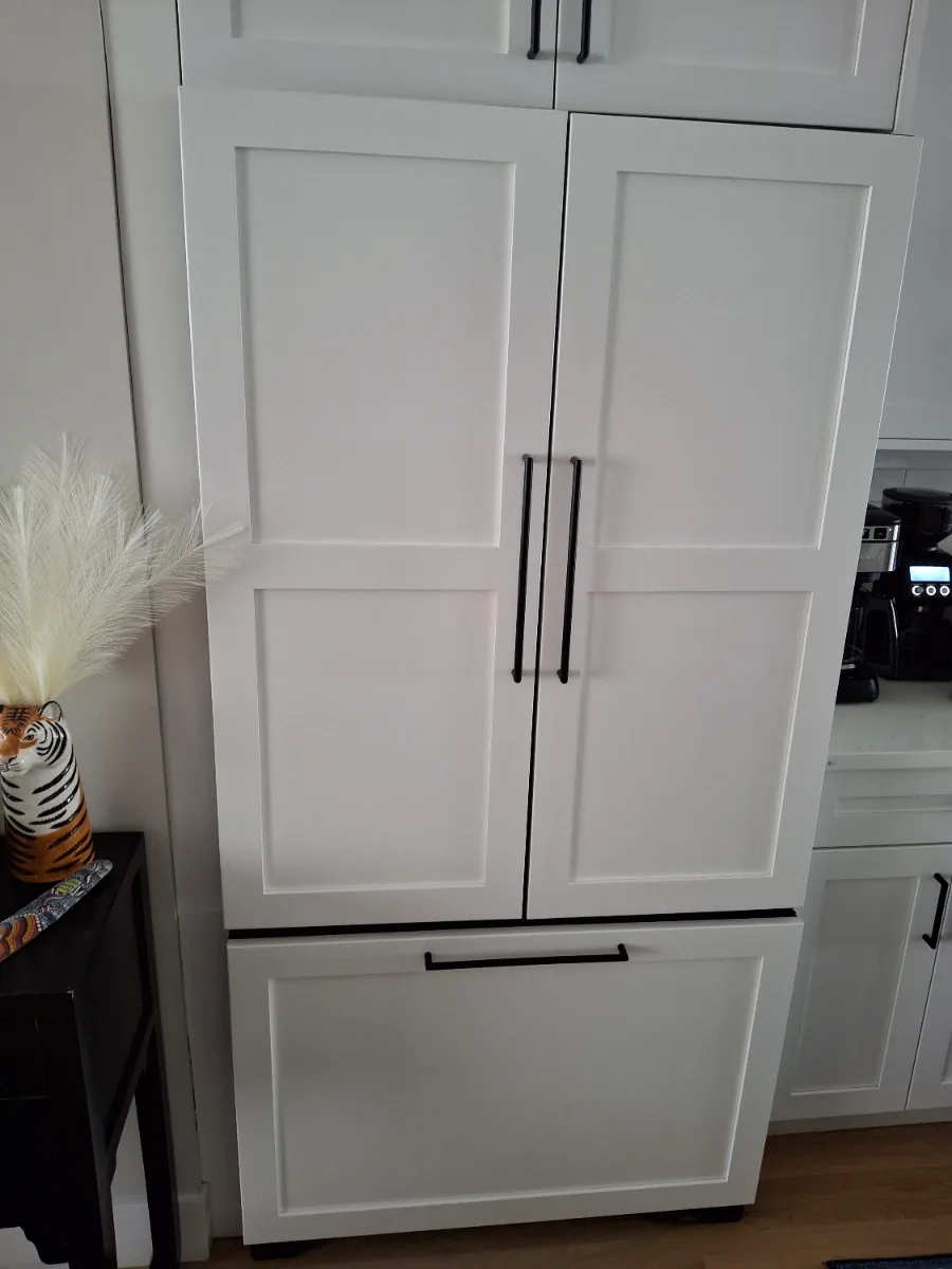 Panel-ready JennAir French door refrigerator with a water dispenser inside