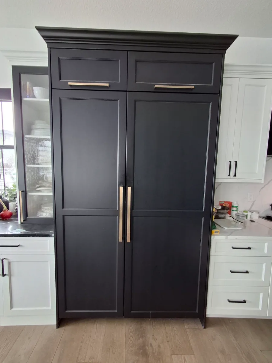 Panel-ready JennAir built-in refrigerator behind black cabinet panels