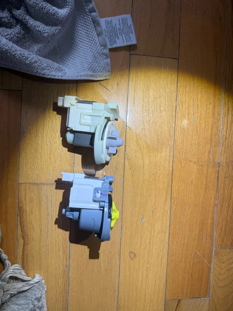 Old and new drain pumps from a Kenmore dishwasher