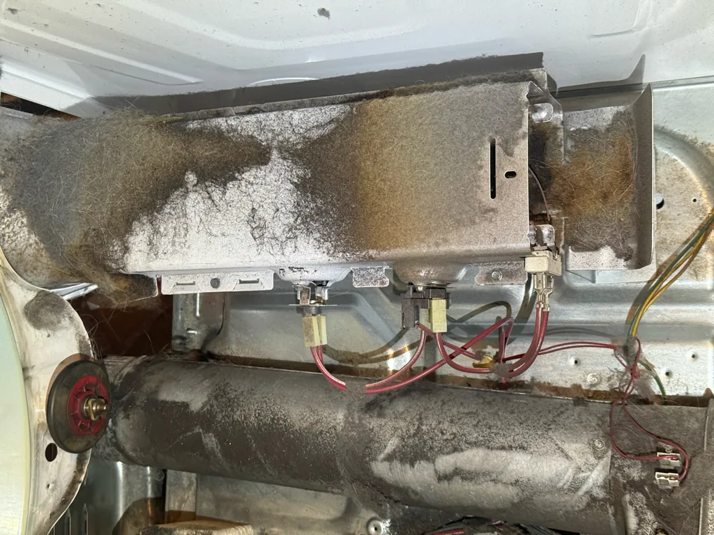 Lint-coated heater housing and duct inside a Kenmore Elite dryer