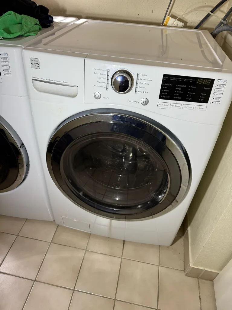 White Kenmore front-load washer, built by LG