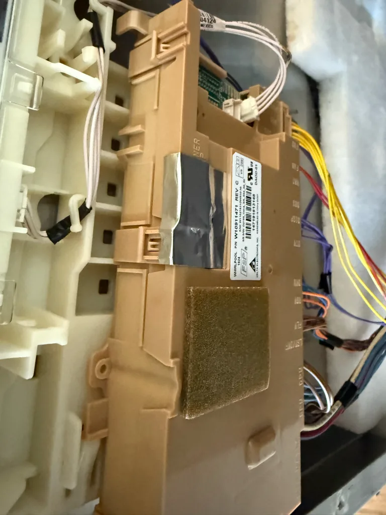 Control board inside the door of a KitchenAid dishwasher