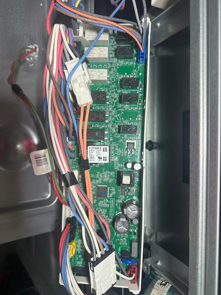 Control board and wiring behind a KitchenAid oven panel