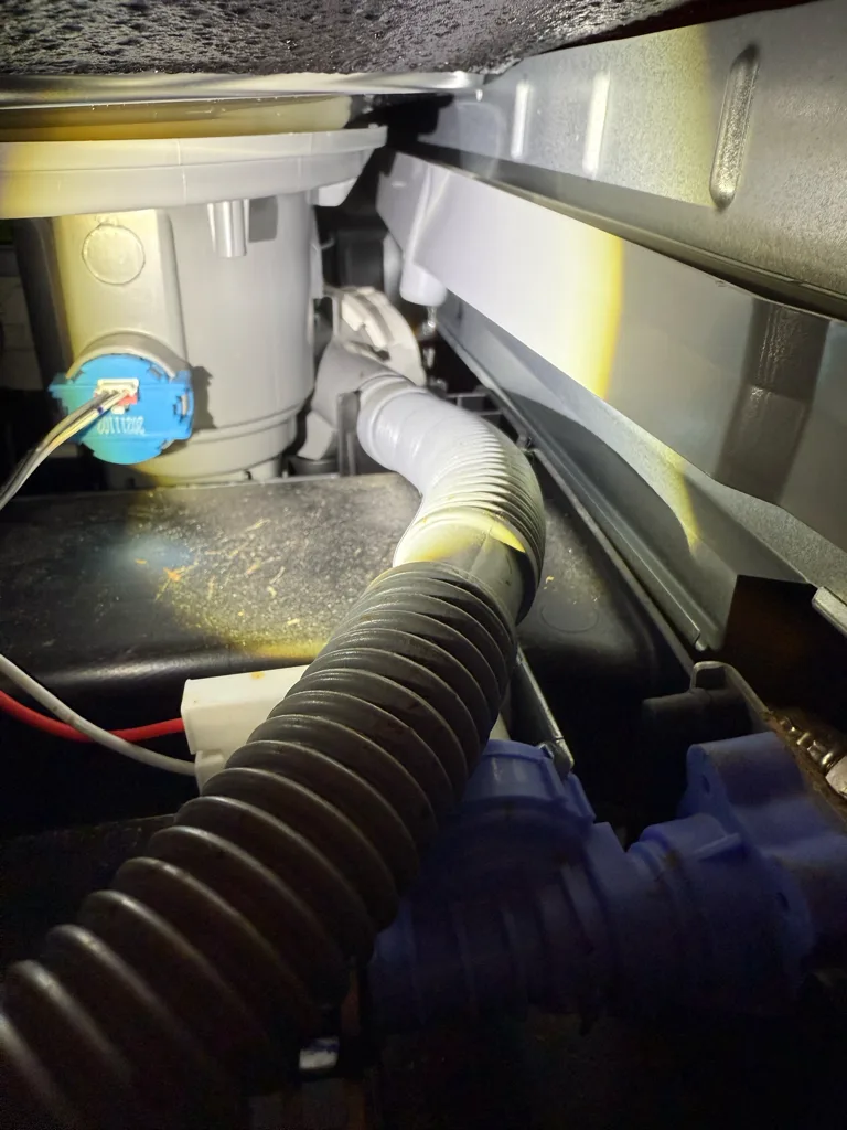 Checking hoses and the base area under an LG dishwasher for the source of a leak
