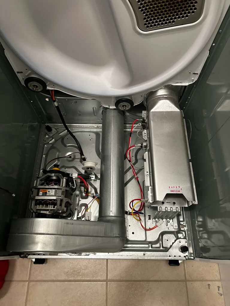 LG dryer with the drum removed showing the motor, blower and heater housing
