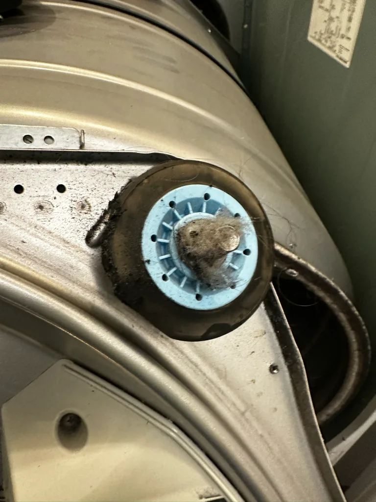 Worn drum support roller on an LG dryer
