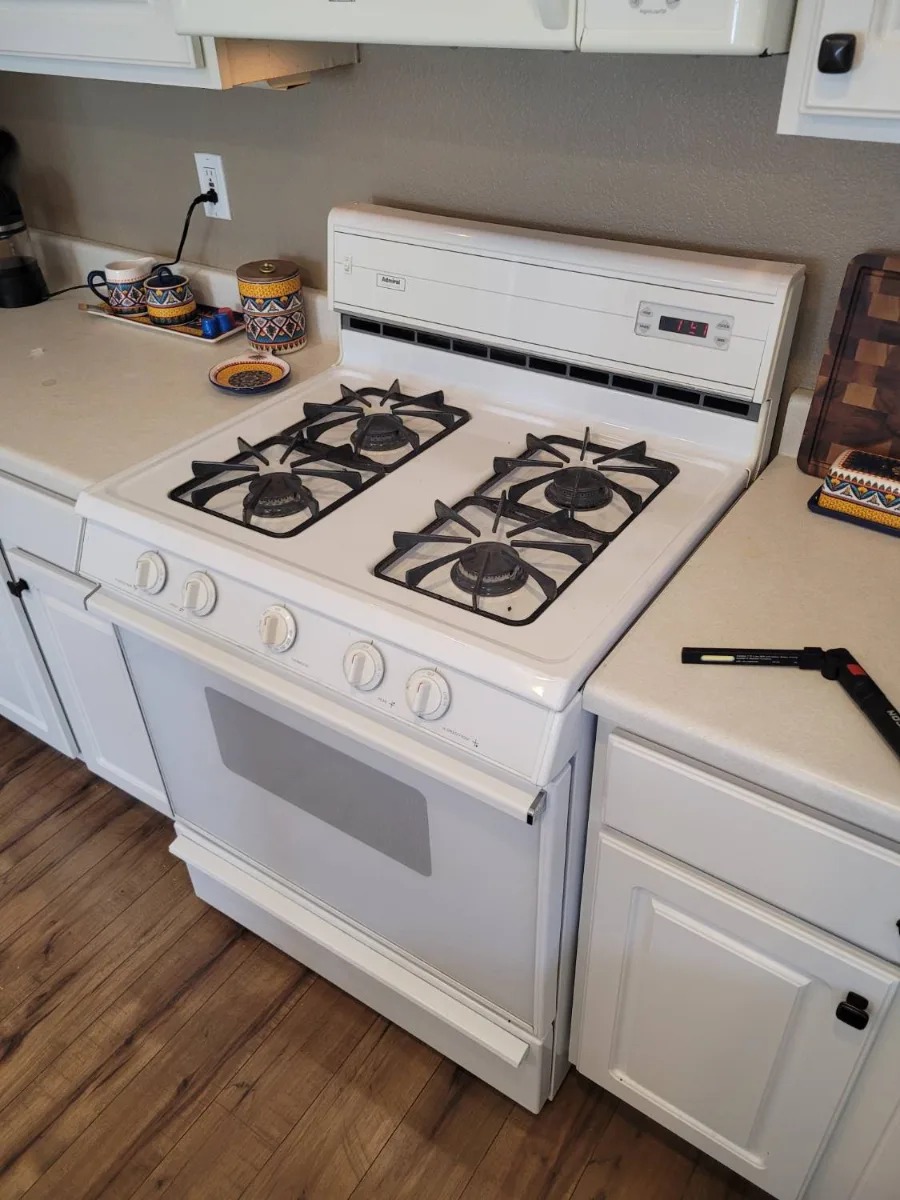 Older white Admiral gas range made by Maytag