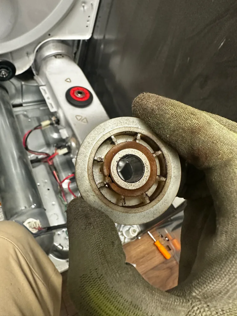 Worn drum support roller from a squealing Maytag dryer
