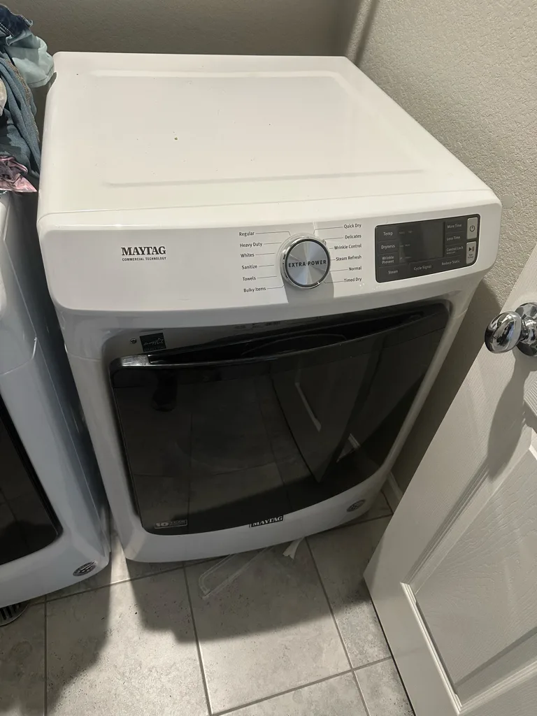 White Maytag front-load dryer in a Denver-area laundry room