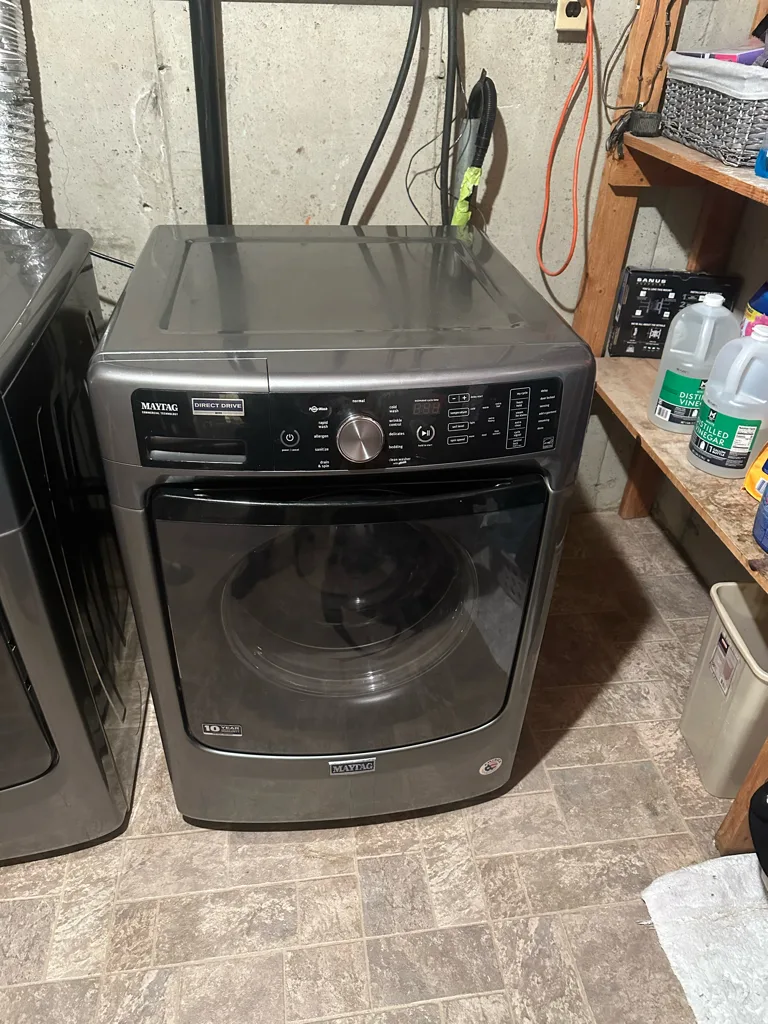 Metallic slate Maytag front-load washer in a Denver-area basement laundry