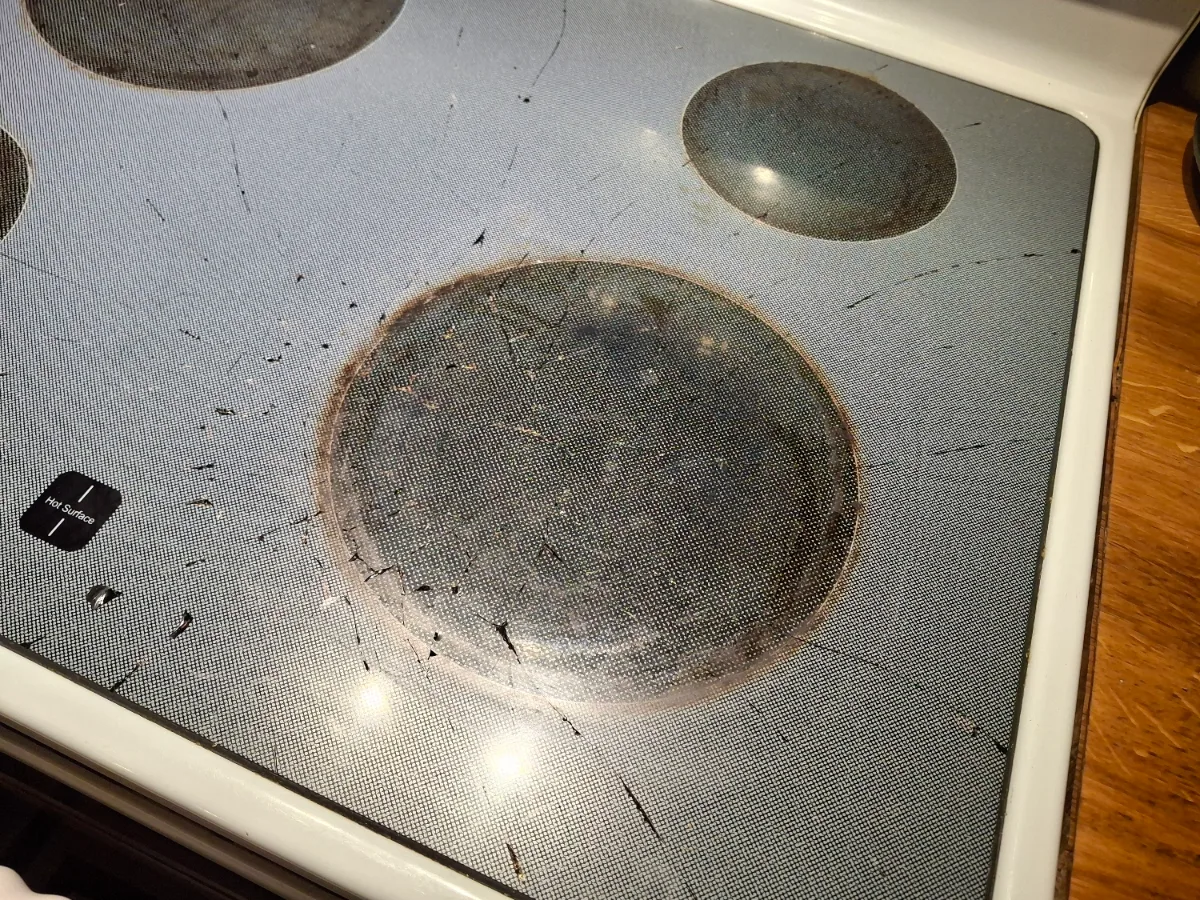 Damaged glass cooktop of a Maytag electric range