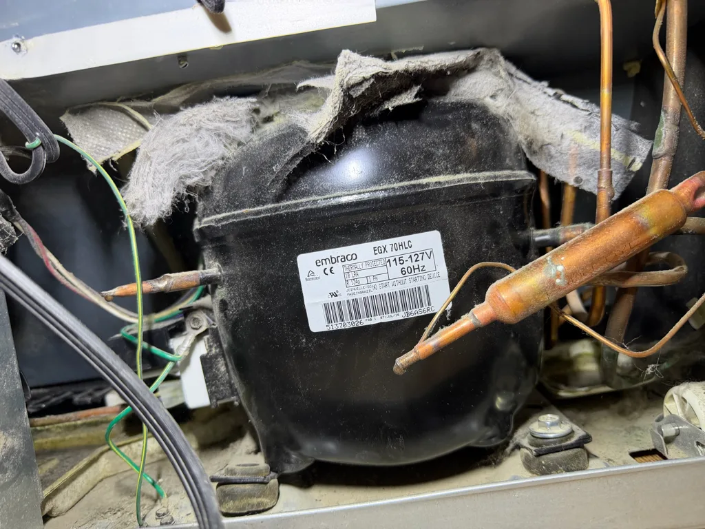 Compressor and relay in the machine compartment of a Maytag refrigerator