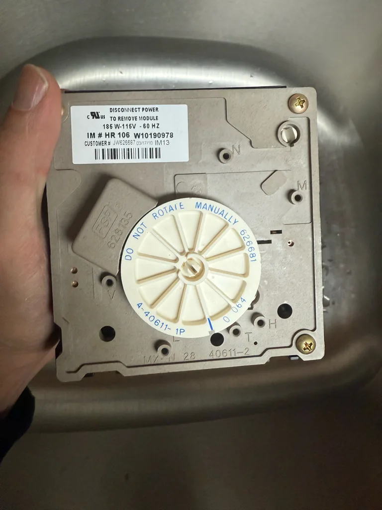 Ice maker control module removed from a Maytag refrigerator