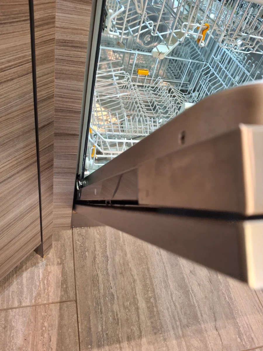 Custom furniture front on a Miele dishwasher door being aligned