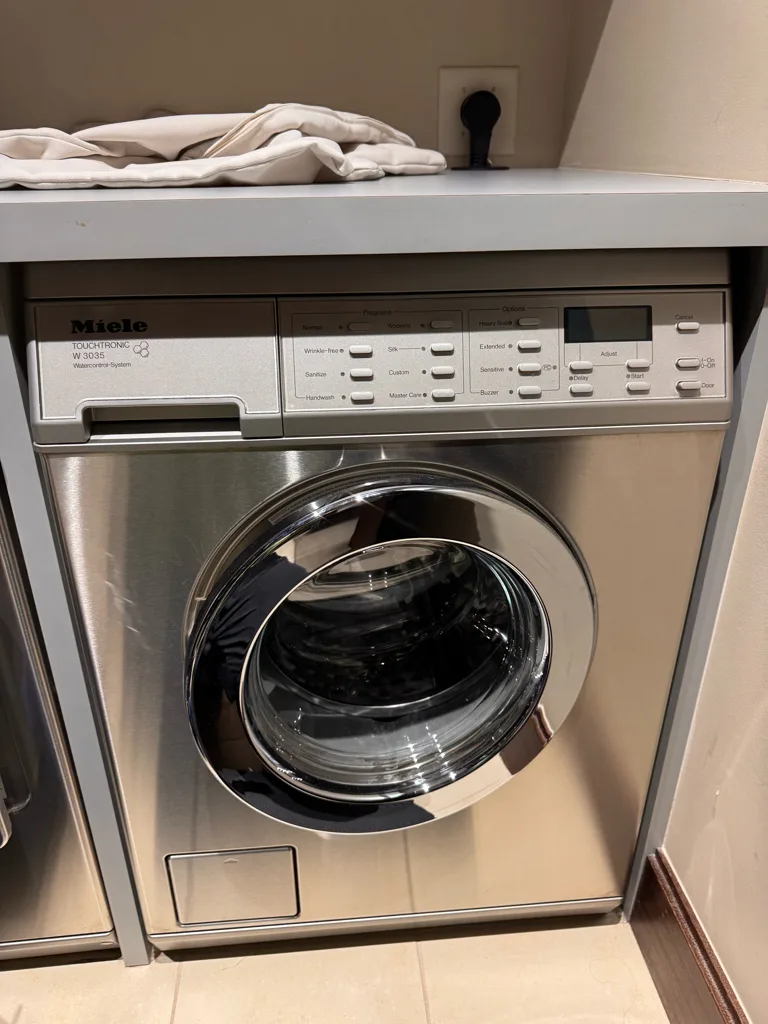 Miele W1 front-load washer in a laundry room