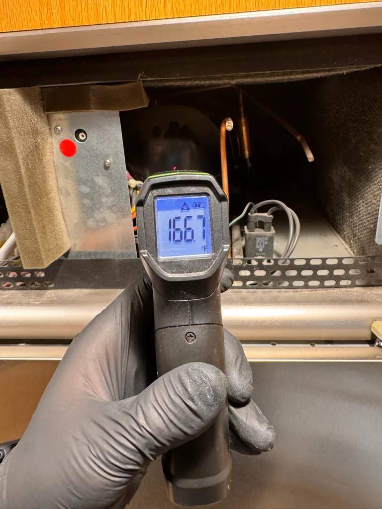 Measuring 166 degrees on the compressor of a Monogram refrigerator