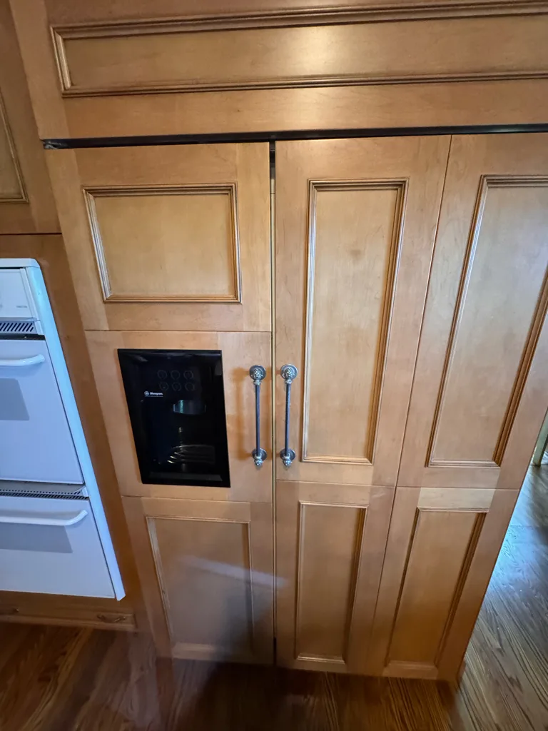 Panel-ready Monogram built-in side-by-side refrigerator with a dispenser