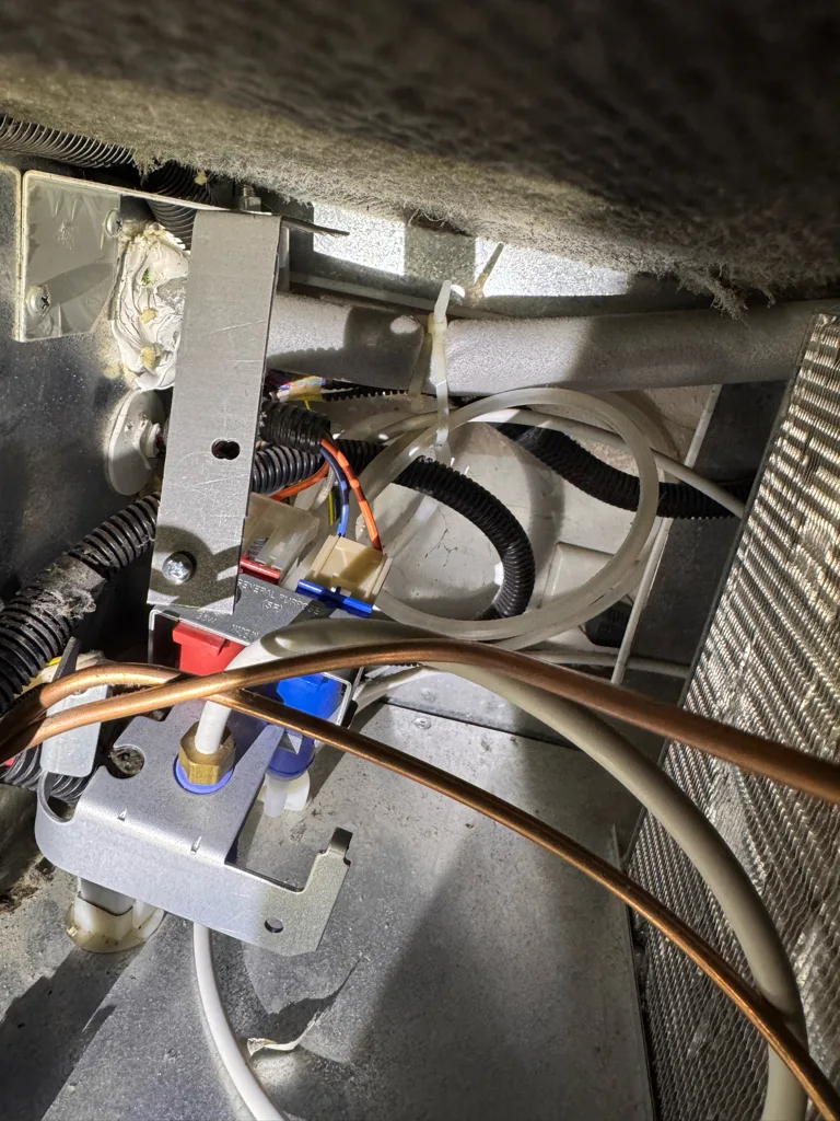 Ice maker fill tube and valve area of a Monogram refrigerator