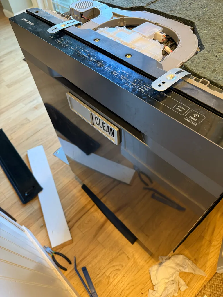 Samsung dishwasher pulled out and laid down to reach the parts underneath