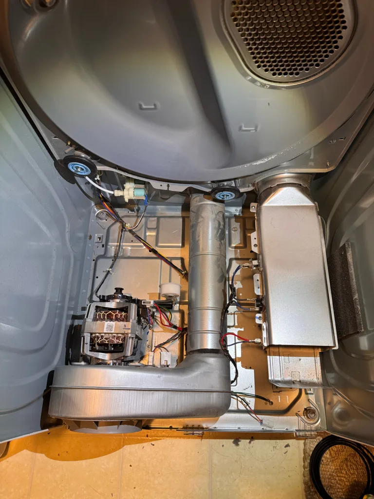 Samsung dryer with the drum removed showing the heater housing, motor and blower