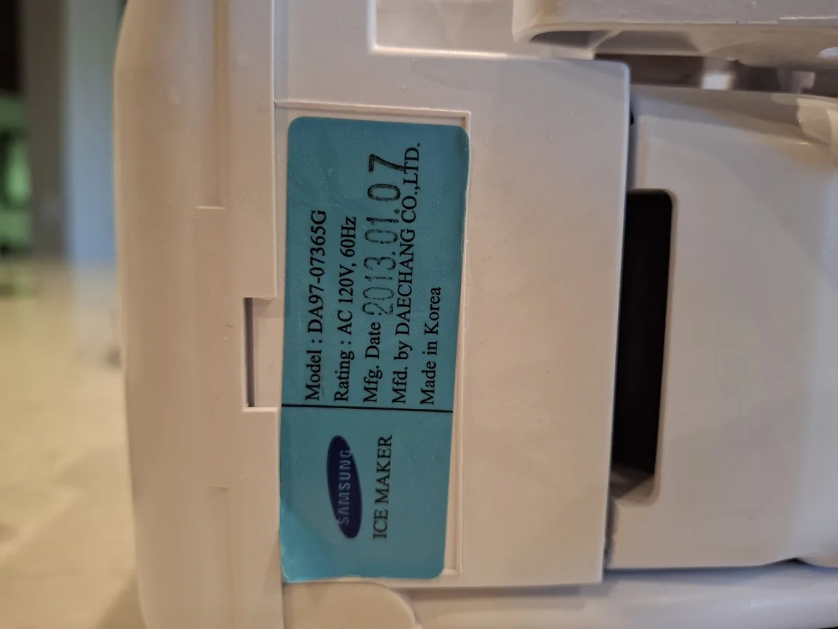 Samsung refrigerator ice maker assembly removed for inspection