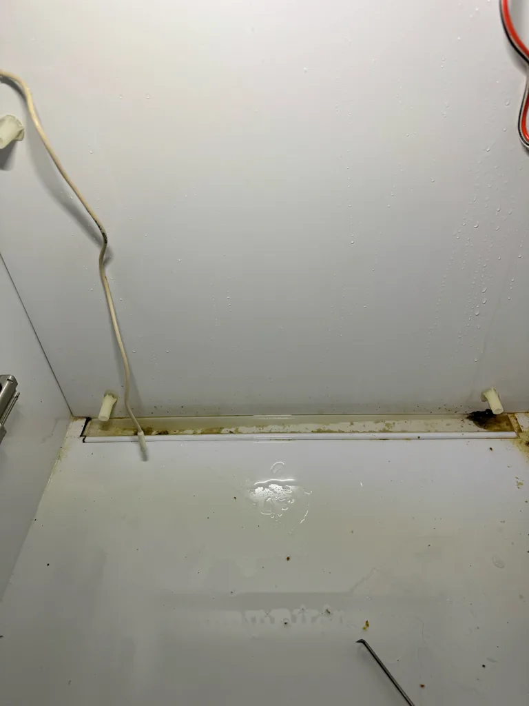Drain trough at the back of a Sub-Zero fresh food section