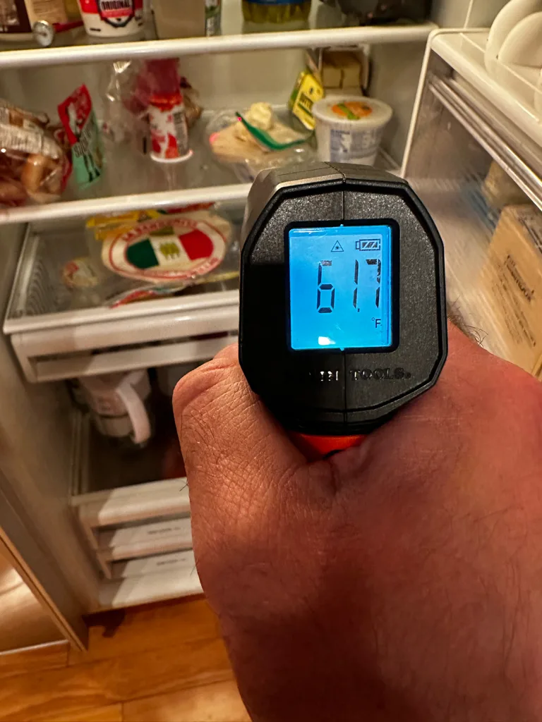 Thermometer reading 61.7 degrees inside the fresh food section of a Sub-Zero
