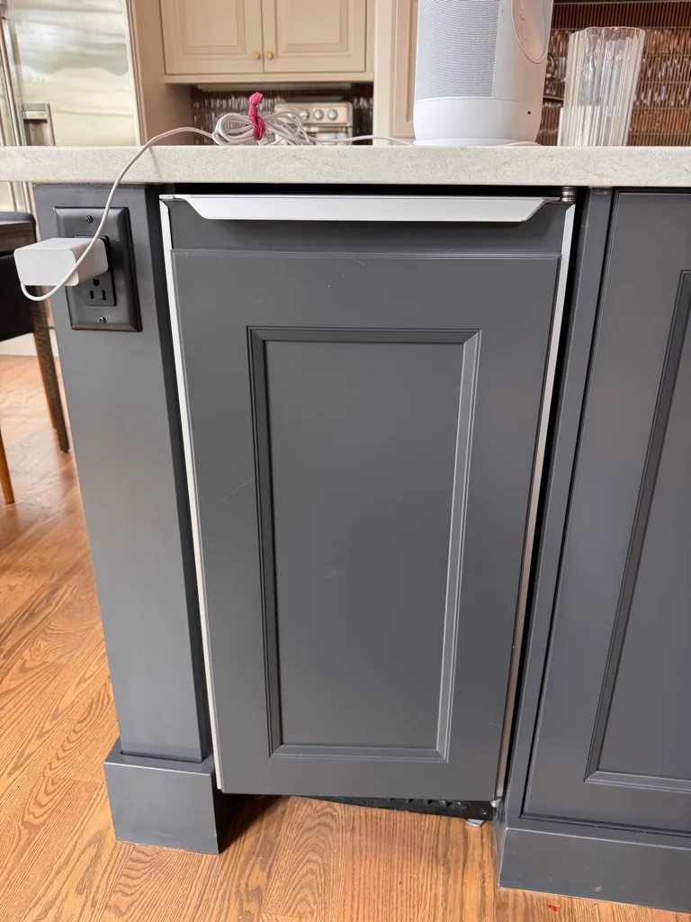Panel-ready Sub-Zero undercounter unit in a kitchen island
