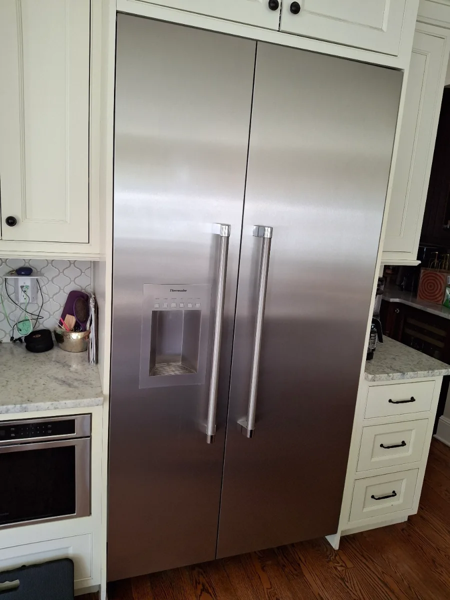 Stainless Thermador built-in refrigerator with a water dispenser