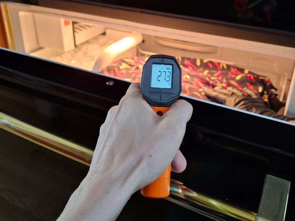 Thermometer reading 27°F in the freezer drawer of a 1990s Viking built-in refrigerator