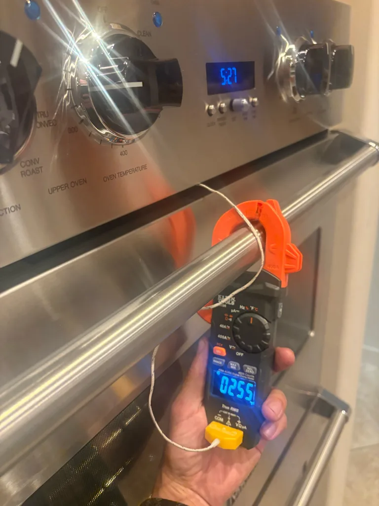 Testing the temperature of a Viking wall oven with a probe and meter
