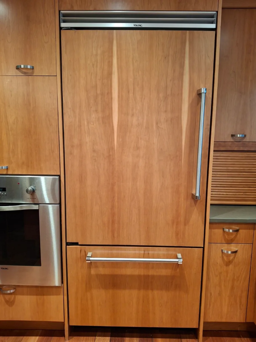 Panel-ready Viking built-in refrigerator behind wood panels