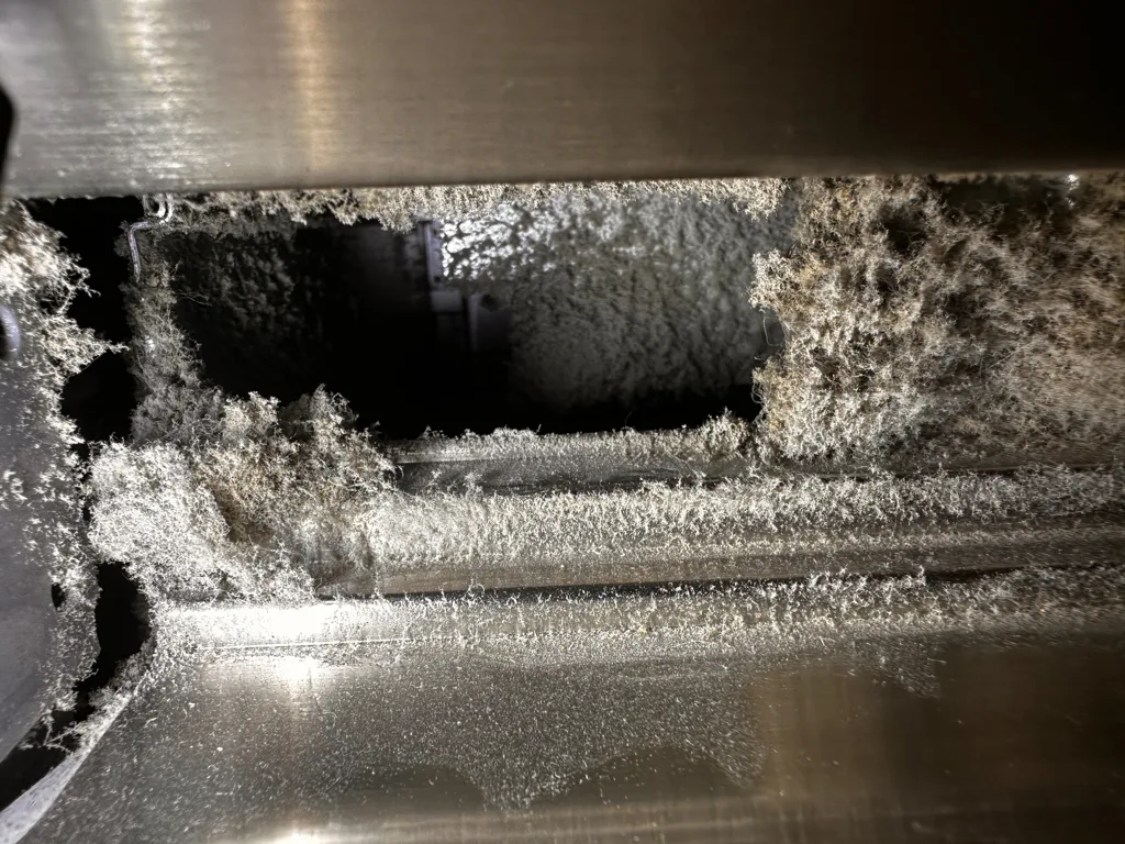Dust packed into the condenser area of a Viking built-in refrigerator