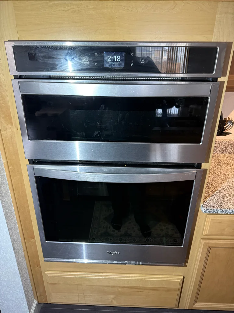 Whirlpool double wall oven in a white kitchen