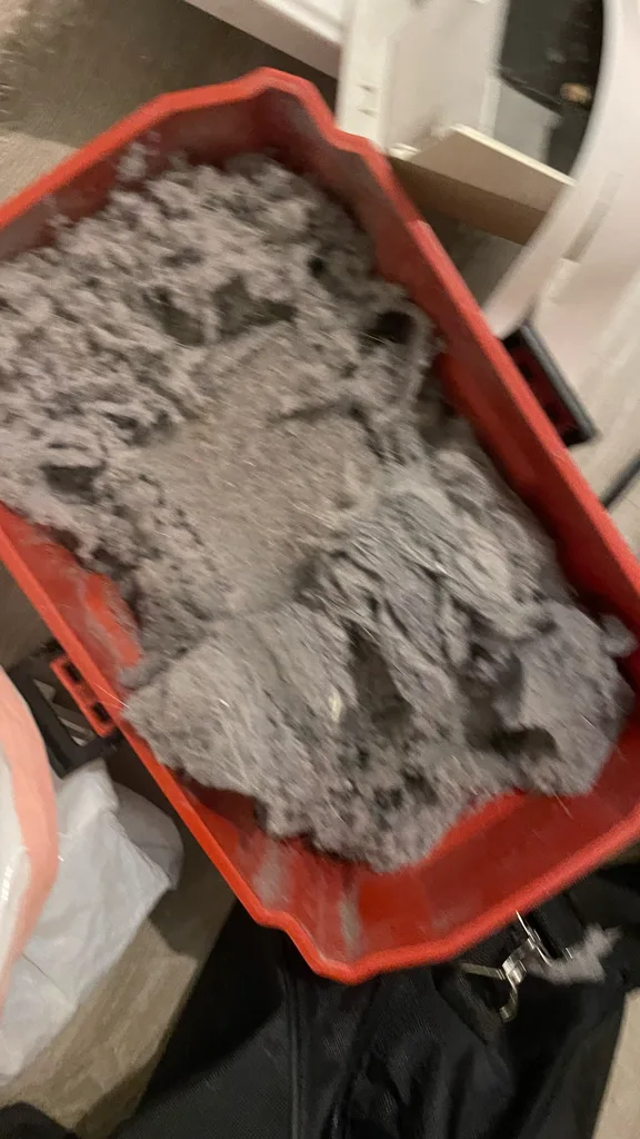 Bin full of lint removed from inside a Whirlpool dryer and its vent