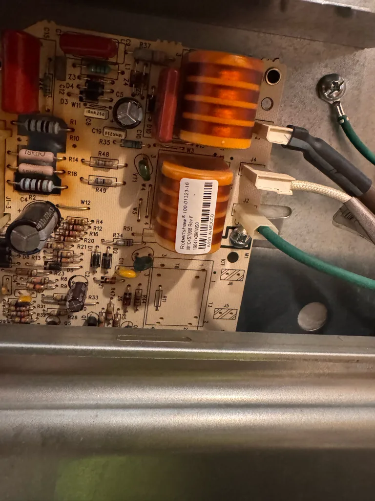 Spark module board inside a Whirlpool gas range